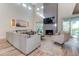 Airy living room with fireplace, comfortable seating, and access to the outdoor spaces at 2414 Goldbug Ave, Sullivans Island, SC 29482