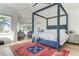 Spacious main bedroom with four poster bed, bay windows, and stylish decor at 2414 Goldbug Ave, Sullivans Island, SC 29482