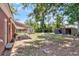Large backyard of a brick house featuring two storage sheds and a covered patio at 245 Clarine Dr, Goose Creek, SC 29445