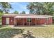 Spacious brick home backyard featuring a covered patio and well-maintained lawn at 245 Clarine Dr, Goose Creek, SC 29445