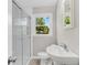 This bathroom features a glass door shower, large mirror, and modern vanity with a window at 245 Clarine Dr, Goose Creek, SC 29445