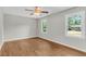 Light-filled bedroom featuring two windows, hardwood floors, and neutral paint at 245 Clarine Dr, Goose Creek, SC 29445