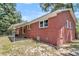 A red brick exterior wall shows the side of the home with the porch and backyard at 245 Clarine Dr, Goose Creek, SC 29445