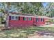 Charming brick home featuring black shutters, a manicured lawn, and a cozy front porch at 245 Clarine Dr, Goose Creek, SC 29445