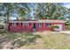 Charming red brick home featuring black shutters and a well-maintained front yard at 245 Clarine Dr, Goose Creek, SC 29445
