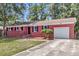 Lovely brick home with black shutters, a well-kept lawn, and an attached garage at 245 Clarine Dr, Goose Creek, SC 29445