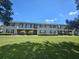 Charming two-story townhome featuring a well-maintained lawn and classic architectural details under a sunny sky at 2494 Etiwan Ave # 3I, Charleston, SC 29414