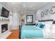 Comfortable main bedroom features a fireplace, light-blue walls, wood floors, and many windows at 2705 Parkers Landing Rd, Mount Pleasant, SC 29466