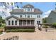 View of the backyard with a brick patio, outdoor kitchen, screened porch and manicured landscaping at 3028 River Vista Drive Way, Mount Pleasant, SC 29466