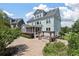 Stunning backyard with brick patio, outdoor kitchen, screened porch and manicured landscaping at 3028 River Vista Drive Way, Mount Pleasant, SC 29466
