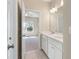 Bathroom showcasing dual sinks, a large mirror, and an open doorway to a bedroom at 3028 River Vista Drive Way, Mount Pleasant, SC 29466