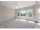 A bright bedroom with large windows, neutral walls, and plush carpeting at 3028 River Vista Drive Way, Mount Pleasant, SC 29466