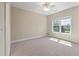Neutral bedroom showcasing a large window providing ample natural light and a ceiling fan at 3028 River Vista Drive Way, Mount Pleasant, SC 29466