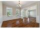 Spacious dining room boasts hardwood floors, white wainscoting, large windows, and elegant lighting fixture at 3028 River Vista Drive Way, Mount Pleasant, SC 29466