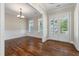 Dining room with hardwood floors, wainscoting, white trim, and elegant lighting at 3028 River Vista Drive Way, Mount Pleasant, SC 29466