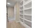 Hallway featuring built-in bookshelves, carpeted floor, white trim, and a door at 3028 River Vista Drive Way, Mount Pleasant, SC 29466