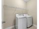 Laundry area featuring a white washer and dryer with wire rack shelving at 3028 River Vista Drive Way, Mount Pleasant, SC 29466