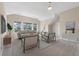 Bright living room with a beige sofa, two armchairs and large windows allowing natural light at 3028 River Vista Drive Way, Mount Pleasant, SC 29466