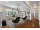 Living room features hardwood floors, large windows, a fireplace, ceiling fan, and an open layout at 3028 River Vista Drive Way, Mount Pleasant, SC 29466