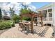 Outdoor kitchen with pergola, table and chairs on brick patio at 3028 River Vista Drive Way, Mount Pleasant, SC 29466
