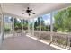 Spacious screened in porch with wood floors and white railings offering serene views of the landscaped backyard at 3028 River Vista Drive Way, Mount Pleasant, SC 29466