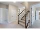 Carpeted staircase with wooden handrail and white balusters, leading to upper level at 3028 River Vista Drive Way, Mount Pleasant, SC 29466