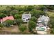 A lovely neighborhood with landscaped lots and mature trees surrounding a luxury home and pool at 31 Seagrass Ln, Isle of Palms, SC 29451