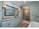 Spacious bathroom with double sinks, granite countertops, and a soaking tub nearby at 31 Seagrass Ln, Isle of Palms, SC 29451