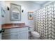 Charming bathroom with granite countertops, vanity, patterned shower curtain, and modern fixtures at 31 Seagrass Ln, Isle of Palms, SC 29451