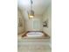 Modern bathroom with a soaking tub and stylish light fixture at 31 Seagrass Ln, Isle of Palms, SC 29451