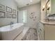 Relaxing bathroom featuring a standalone tub, vanity with granite countertops and modern fixtures at 31 Seagrass Ln, Isle of Palms, SC 29451