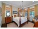 Warm bedroom with a four-poster bed, soft lighting, and views of the outdoor scenery at 31 Seagrass Ln, Isle of Palms, SC 29451