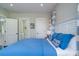 Stylish bedroom with a comfortable blue bed and an ensuite bathroom at 31 Seagrass Ln, Isle of Palms, SC 29451