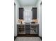 Charming butler's pantry with dark cabinetry, beverage refrigerators, and a countertop with decor at 31 Seagrass Ln, Isle of Palms, SC 29451