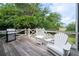 Wooden deck with outdoor furniture, a grill, and views of the lush landscaping at 31 Seagrass Ln, Isle of Palms, SC 29451