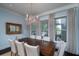 Cozy dining room with a chandelier, large windows, and elegant decor at 31 Seagrass Ln, Isle of Palms, SC 29451