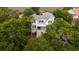Charming home with a white exterior and a palm tree in the front yard at 31 Seagrass Ln, Isle of Palms, SC 29451