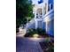 Attractive home with a side entrance and stairway surrounded by lush landscaping and a brick walkway at 31 Seagrass Ln, Isle of Palms, SC 29451