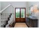 Inviting foyer featuring a staircase, wood floors, and natural light at 31 Seagrass Ln, Isle of Palms, SC 29451