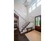 Open foyer with staircase, dark wood floors, and a rustic bench at 31 Seagrass Ln, Isle of Palms, SC 29451