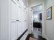 Hallway with built-in storage leading to a well-equipped laundry room with natural light at 31 Seagrass Ln, Isle of Palms, SC 29451