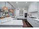 Bright kitchen boasts white cabinets, stainless appliances, and a large island with counter seating at 31 Seagrass Ln, Isle of Palms, SC 29451