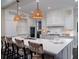 Open concept kitchen with island seating, pendant lights, and stainless appliances at 31 Seagrass Ln, Isle of Palms, SC 29451