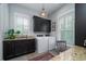 Bright laundry room with modern appliances, granite countertops, and ample storage at 31 Seagrass Ln, Isle of Palms, SC 29451