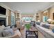 Cozy living room with a fireplace, built-in bookshelves, and window seating at 31 Seagrass Ln, Isle of Palms, SC 29451