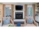 Living room with fireplace flanked by built-ins and doors to the outside at 31 Seagrass Ln, Isle of Palms, SC 29451