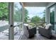 Relaxing screened-in porch with comfortable seating overlooking a picturesque backyard at 31 Seagrass Ln, Isle of Palms, SC 29451