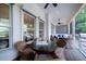 Inviting covered porch with seating area, ceiling fans, and views of the surrounding landscape at 31 Seagrass Ln, Isle of Palms, SC 29451