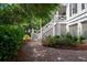 Exterior staircase with a brick path and lush greenery at 31 Seagrass Ln, Isle of Palms, SC 29451