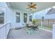 Cozy back porch with comfortable seating, ceiling fan and decorative rug to enjoy outdoor relaxation at 312 Cypress Knee Landing, Summerville, SC 29483